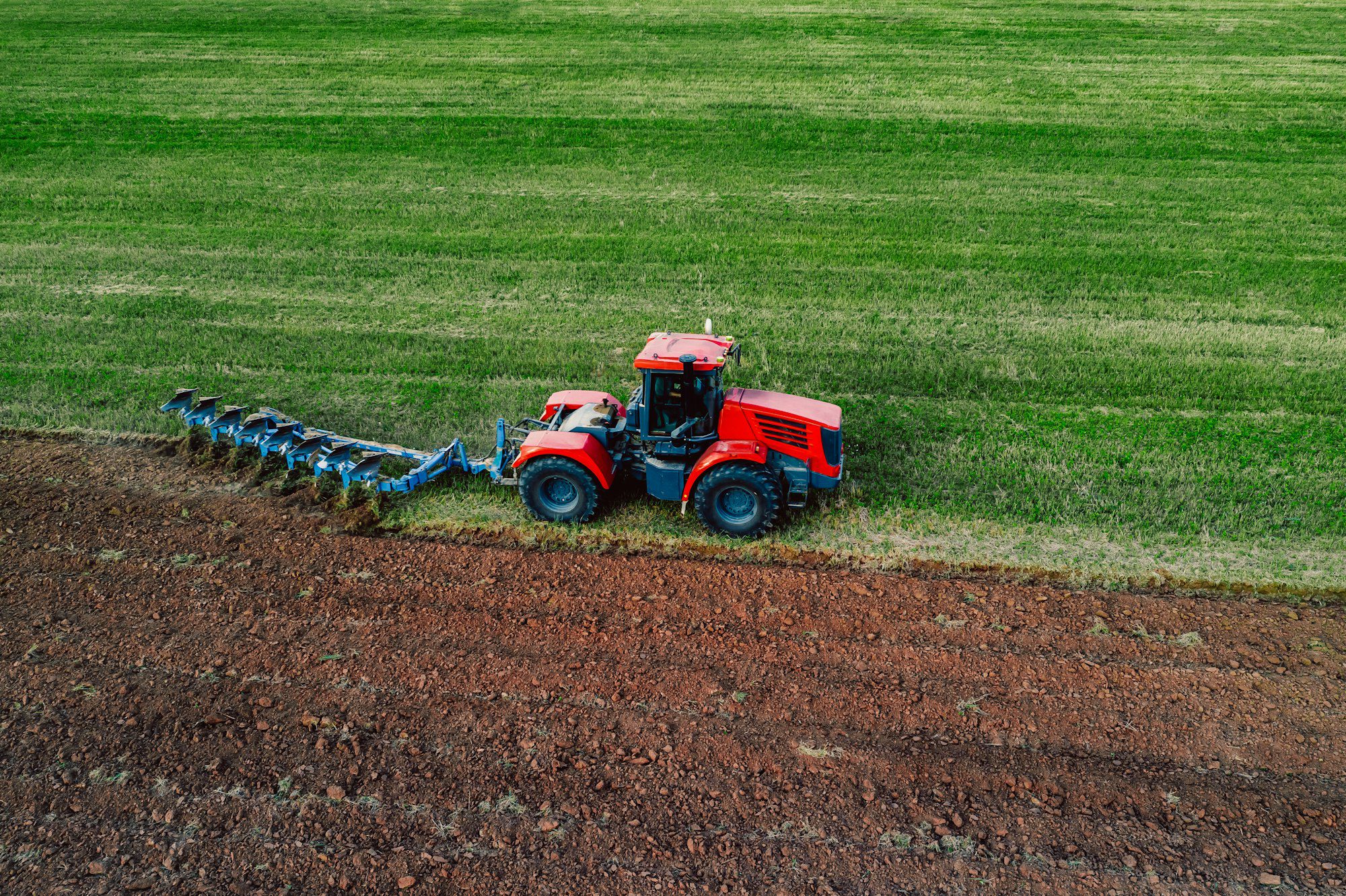 Aerial View of Tractor Plowing Field